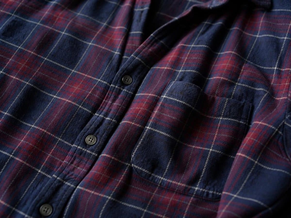 A navy and red flannel shirt laid flat